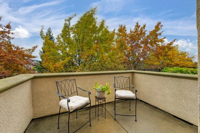a balcony with table and chairs