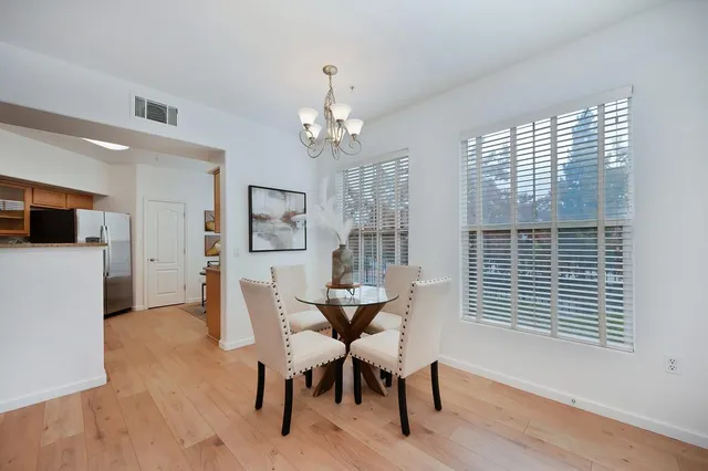 a view of a dining room with furniture window and wooden floor