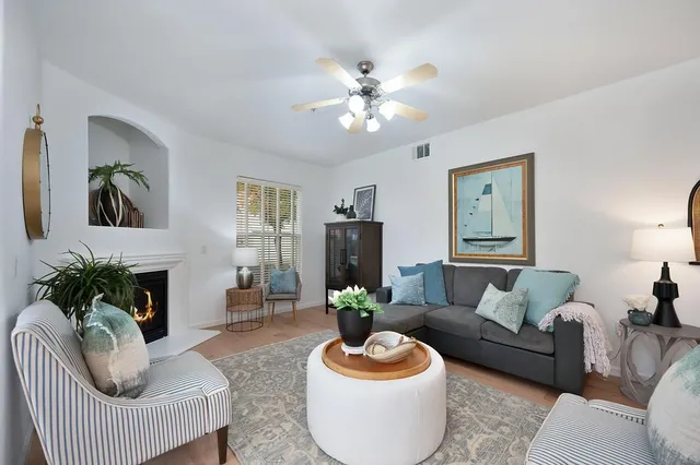 a living room with furniture and a fireplace