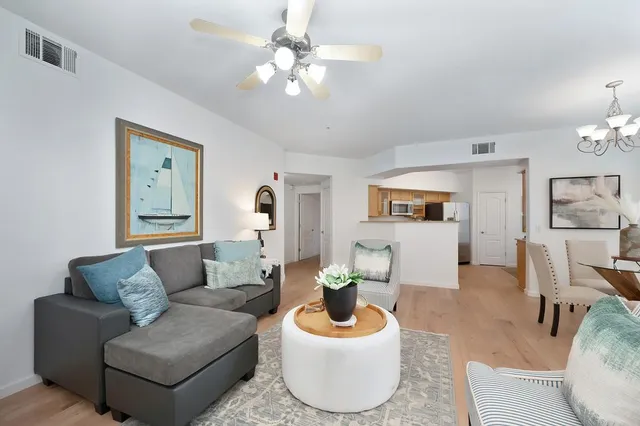 a living room with furniture and a chandelier