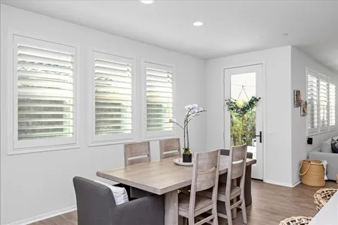 a view of a dining room with furniture and window