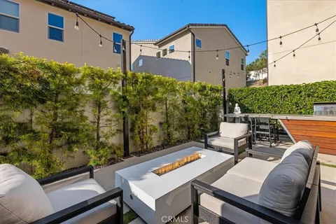 a view of a patio with table and chairs and potted plants