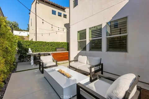 a view of a patio with a table and chairs and potted plants