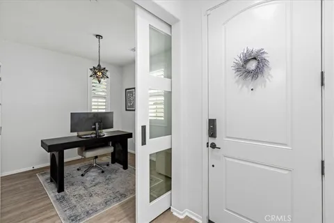 a view of a hallway with workspace and mirror