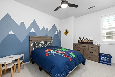 a bedroom with a bed and a dresser in it