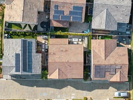 an aerial view of a residential houses with outdoor space