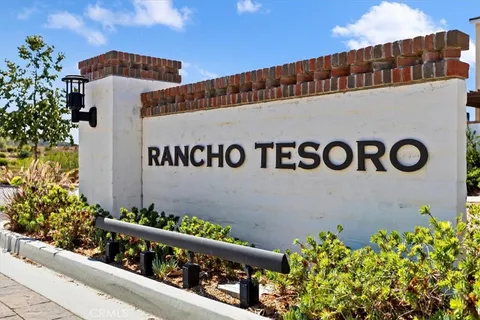a outdoor living room with patio furniture and plants