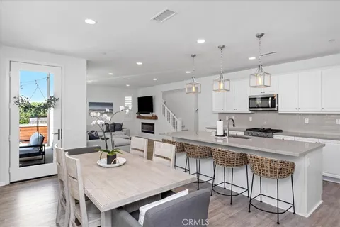 a large kitchen with a table and chairs