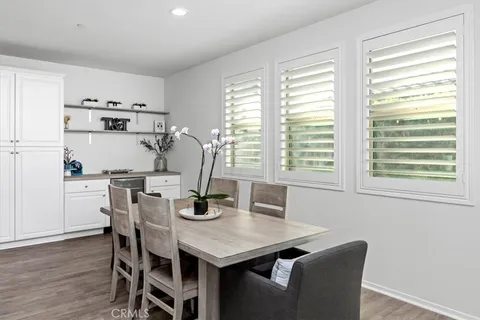 a view of a dining room with furniture and wooden floor