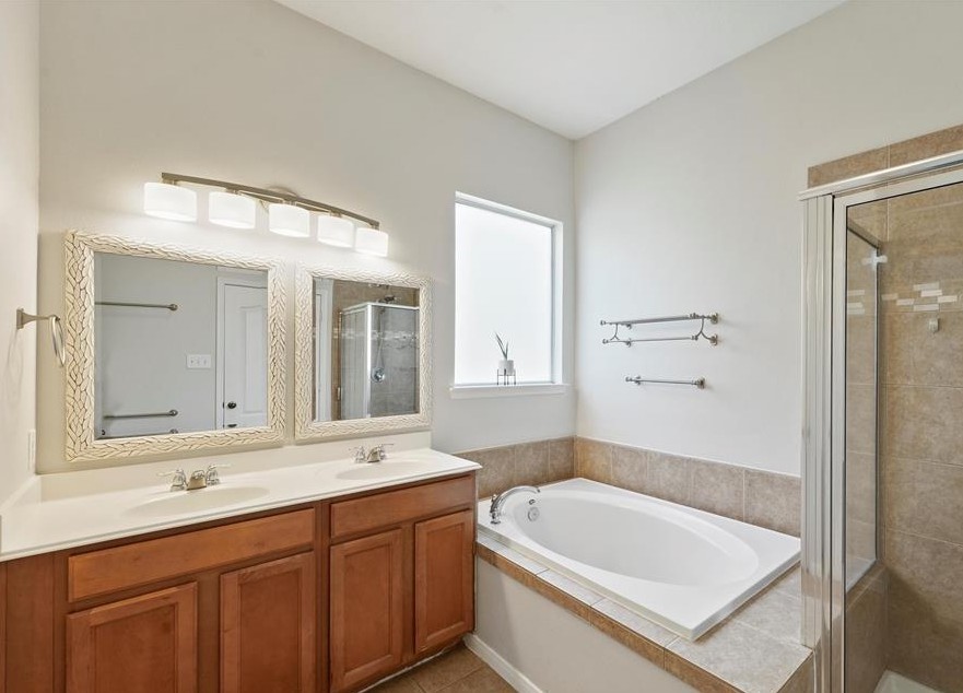 31030 Imperial Walk Lane Spring, TX 77386 - Photo 13 of 19 a bathroom with a tub a sink and mirror