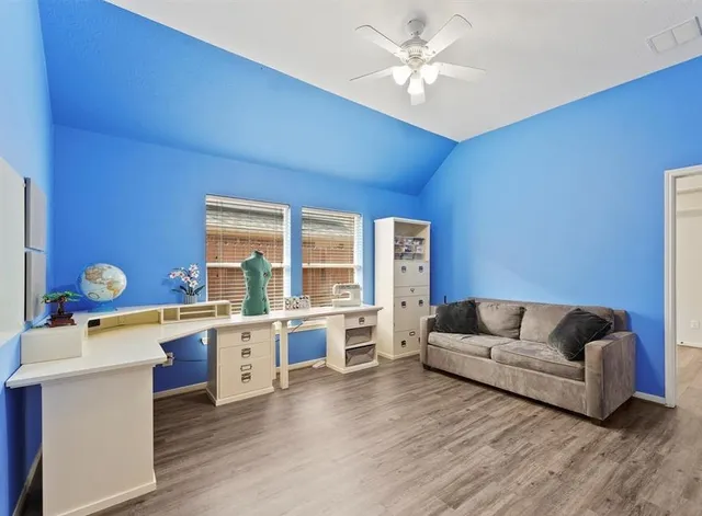 a living room with stainless steel appliances granite countertop furniture and a wooden floors