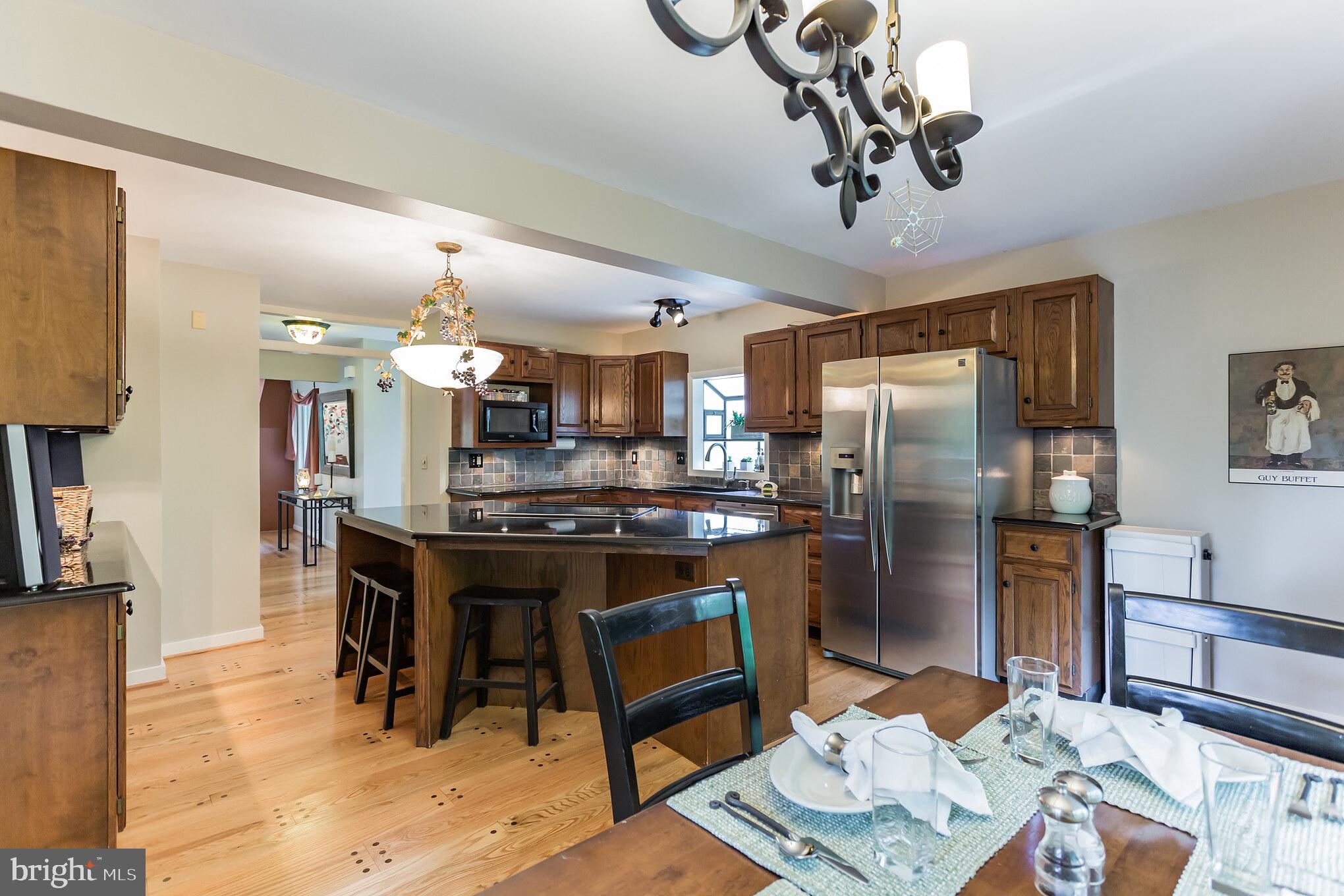 405 Snuff Mill Hill Road Hockessin, DE 19707 - Photo 15 of 41 Kitchen with Hardwood Floors and Fireplace