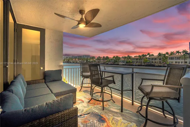 a balcony with table and chairs