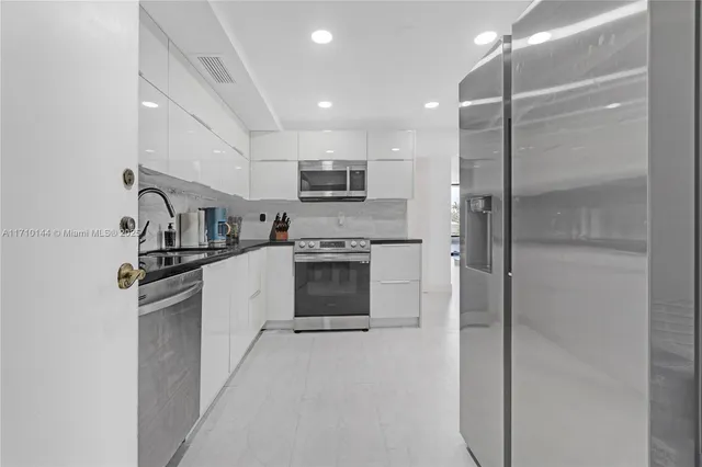 a kitchen with cabinets and stainless steel appliances