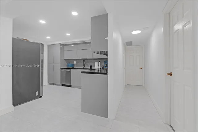 a view of kitchen refrigerator and window