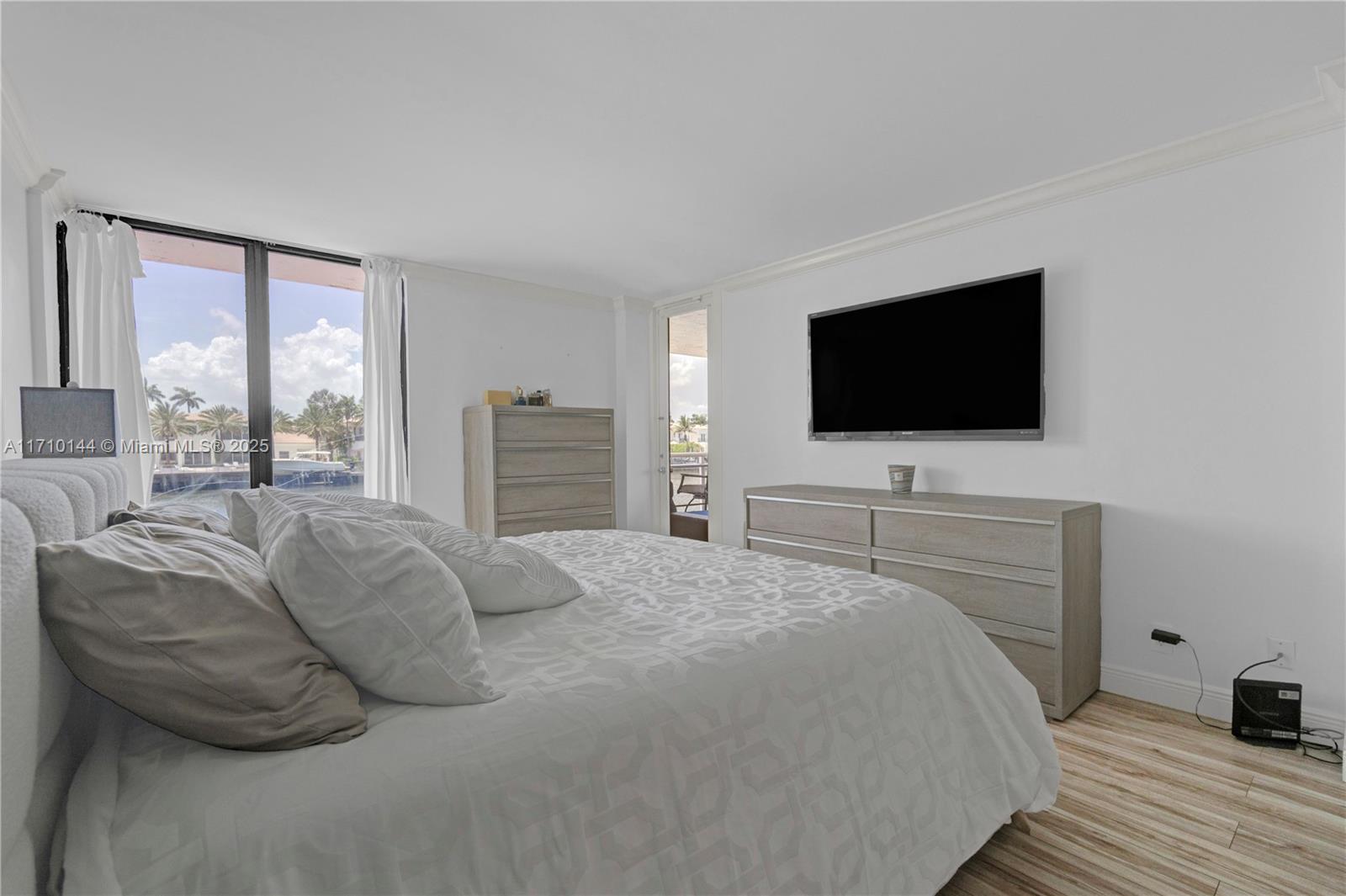 1600 South Ocean Drive, Unit 2F Hollywood, FL 33019 - Photo 13 of 30 a bedroom with a bed and a flat screen tv