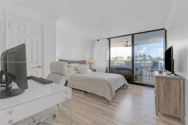 a bedroom with two beds and a flat screen tv