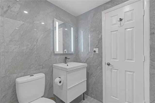 a spacious bathroom with a toilet sink shower and mirror