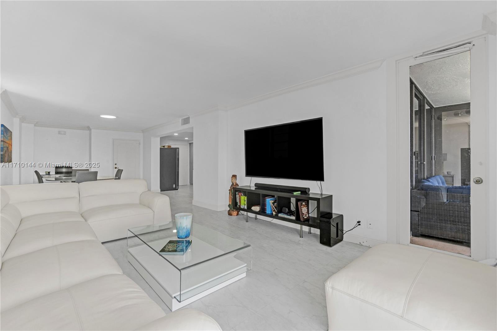1600 South Ocean Drive, Unit 2F Hollywood, FL 33019 - Photo 2 of 30 a living room with furniture and a flat screen tv