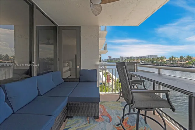 a balcony with table and chairs