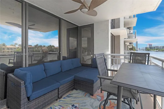 a living room with furniture a large window and a table