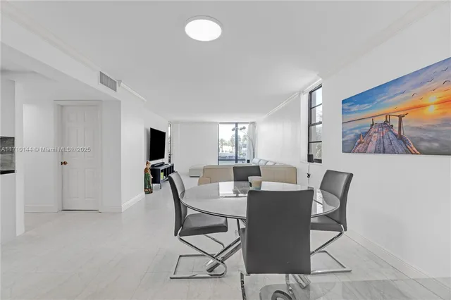a view of a dining room with furniture and a window
