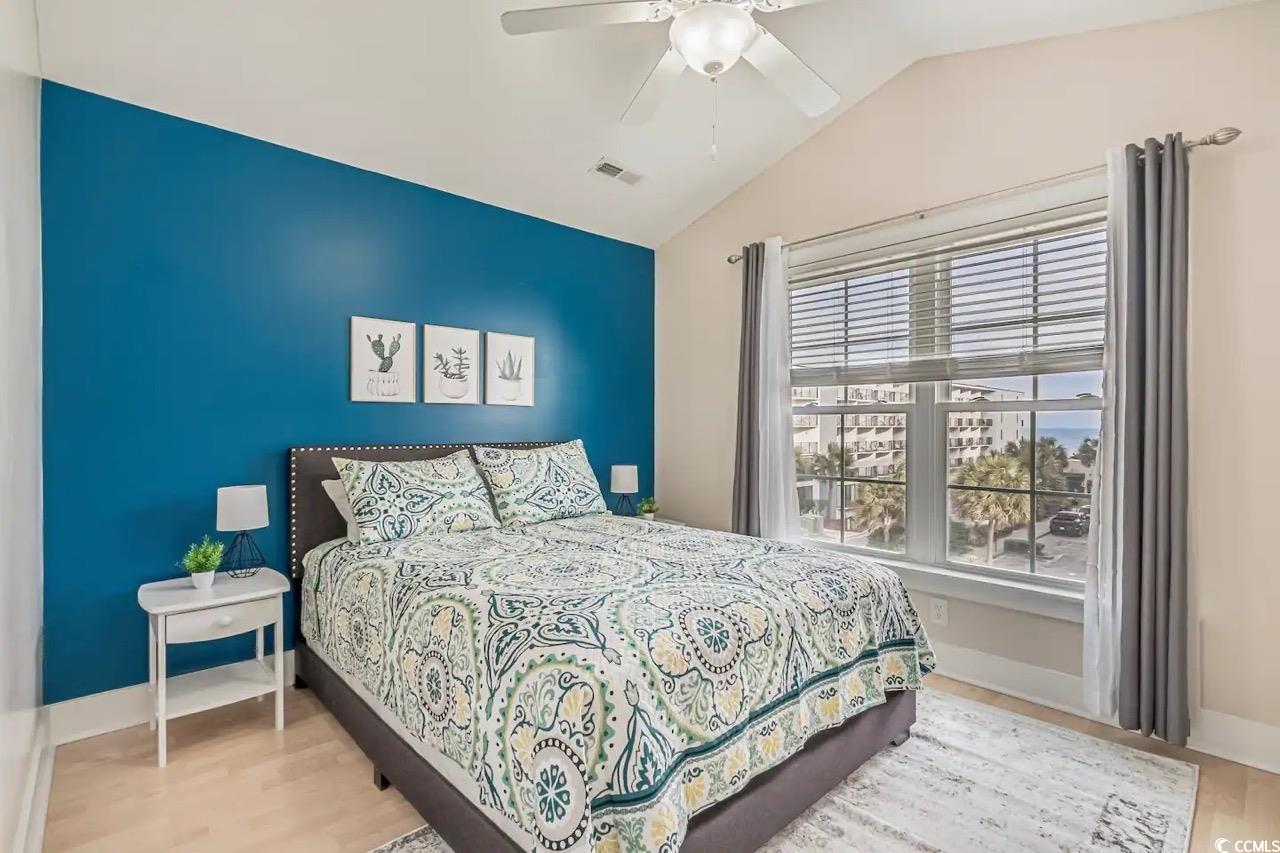 2701 Kashton Street Myrtle Beach, SC 29577 - Photo 14 of 23 Bedroom featuring vaulted ceiling, wood finished floors, and ceiling fan
