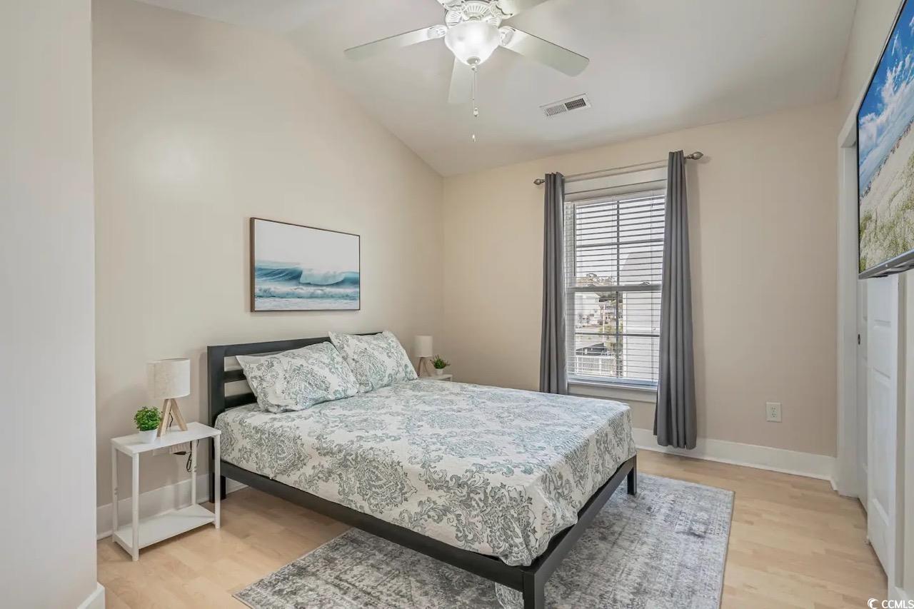 2701 Kashton Street Myrtle Beach, SC 29577 - Photo 20 of 23 Bedroom with light wood-style flooring, vaulted ceiling, and a ceiling fan