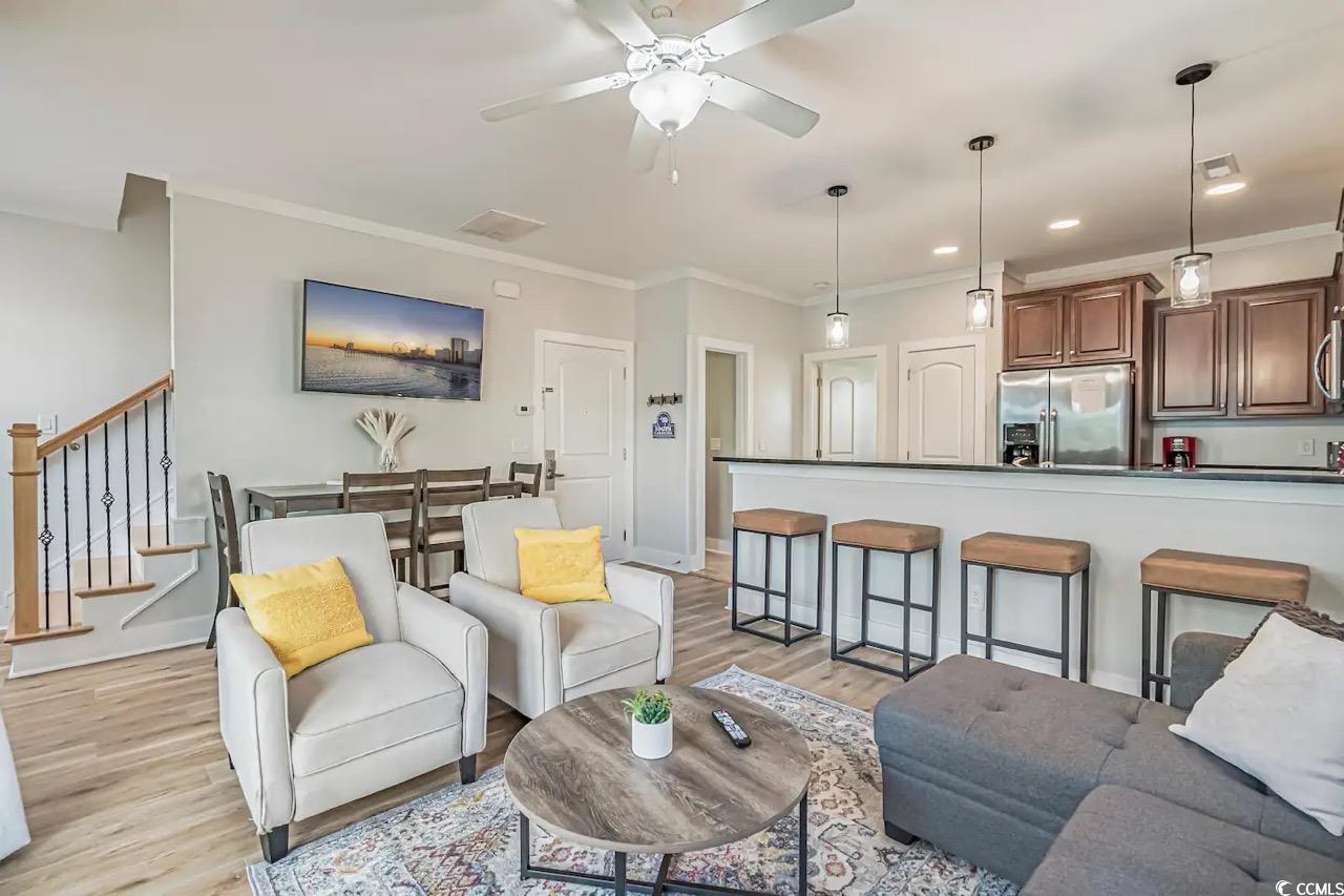 2701 Kashton Street Myrtle Beach, SC 29577 - Photo 4 of 23 Living area featuring light wood finished floors, crown molding, ceiling fan, stairway, and recessed lighting