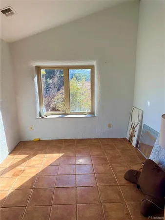 a bedroom with furniture and a rug