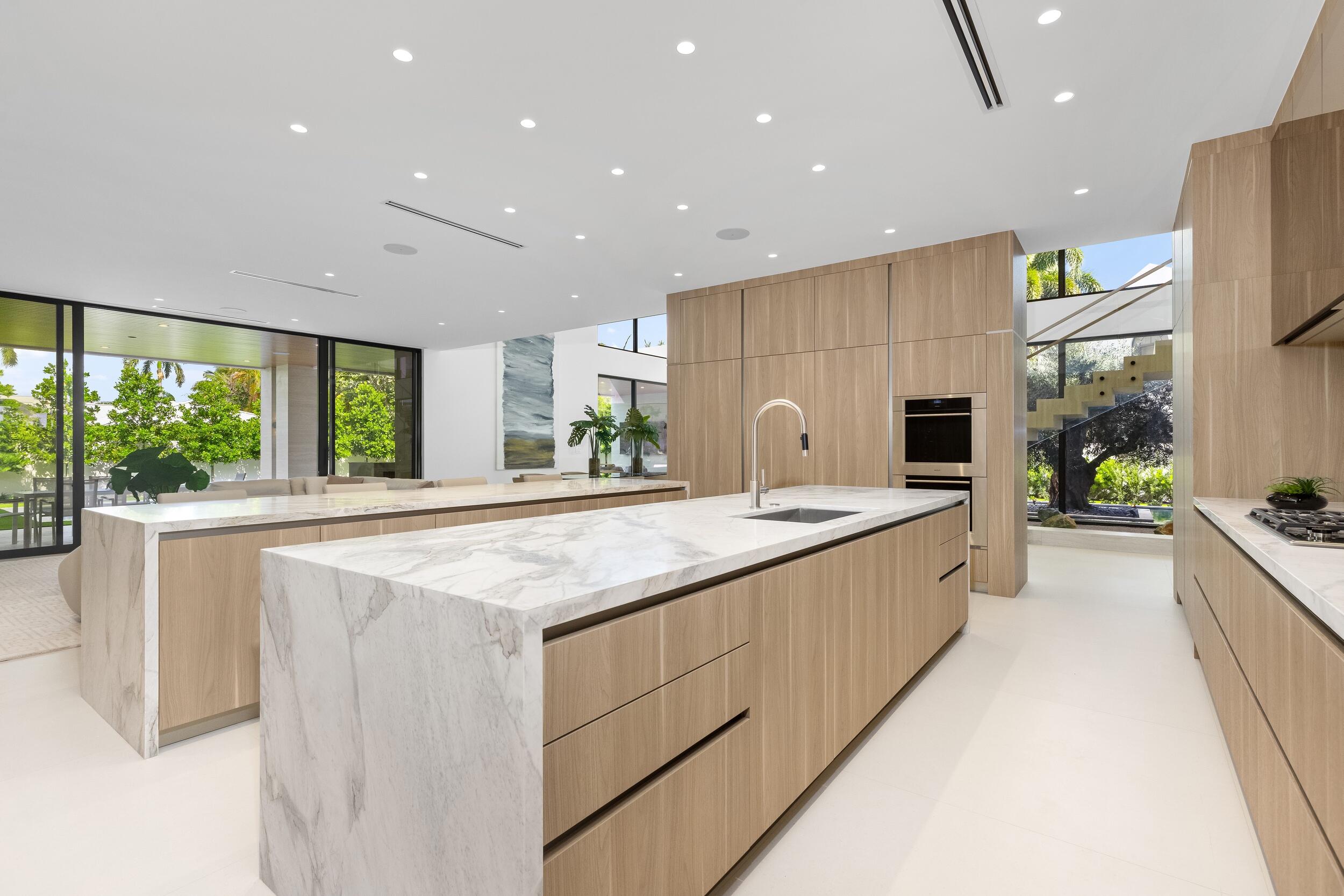 1351 Cocoanut Road Boca Raton, FL 33432 - Photo 40 of 101 a large kitchen with kitchen island a large window a sink and cabinets