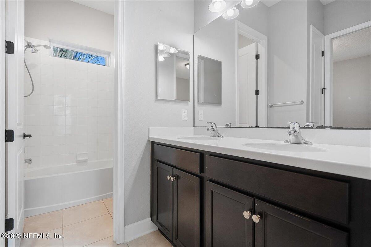 26 Woodview Court Ponte Vedra, FL 32081 - Photo 17 of 71 a bathroom with a double vanity sink a mirror and a bathtub