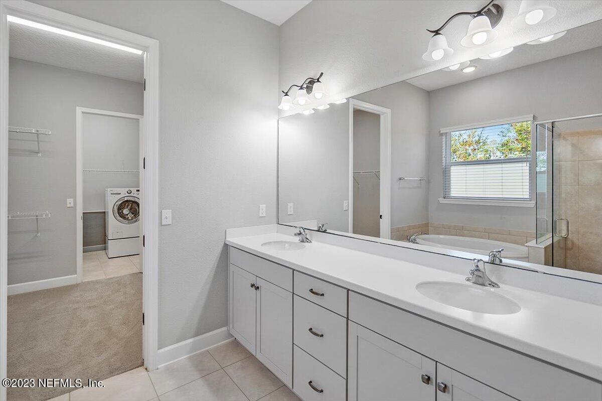 26 Woodview Court Ponte Vedra, FL 32081 - Photo 24 of 71 a bathroom with a double vanity sink a mirror and a shower