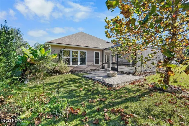 a view of a house with swimming pool and sitting area