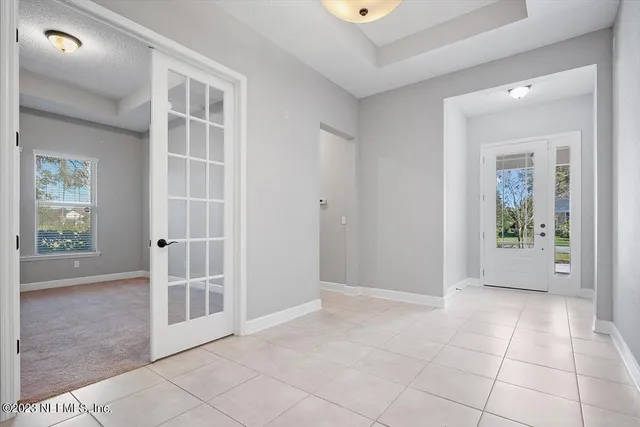 an empty room with windows and outdoor view