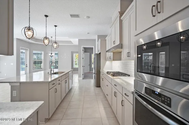 a view of a kitchen with a sink and a large window