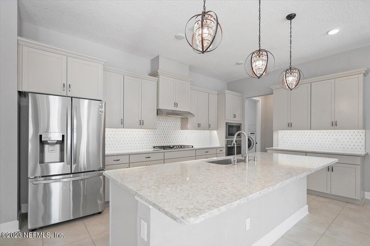 26 Woodview Court Ponte Vedra, FL 32081 - Photo 8 of 71 a kitchen with stainless steel appliances granite countertop a sink a stove and a refrigerator