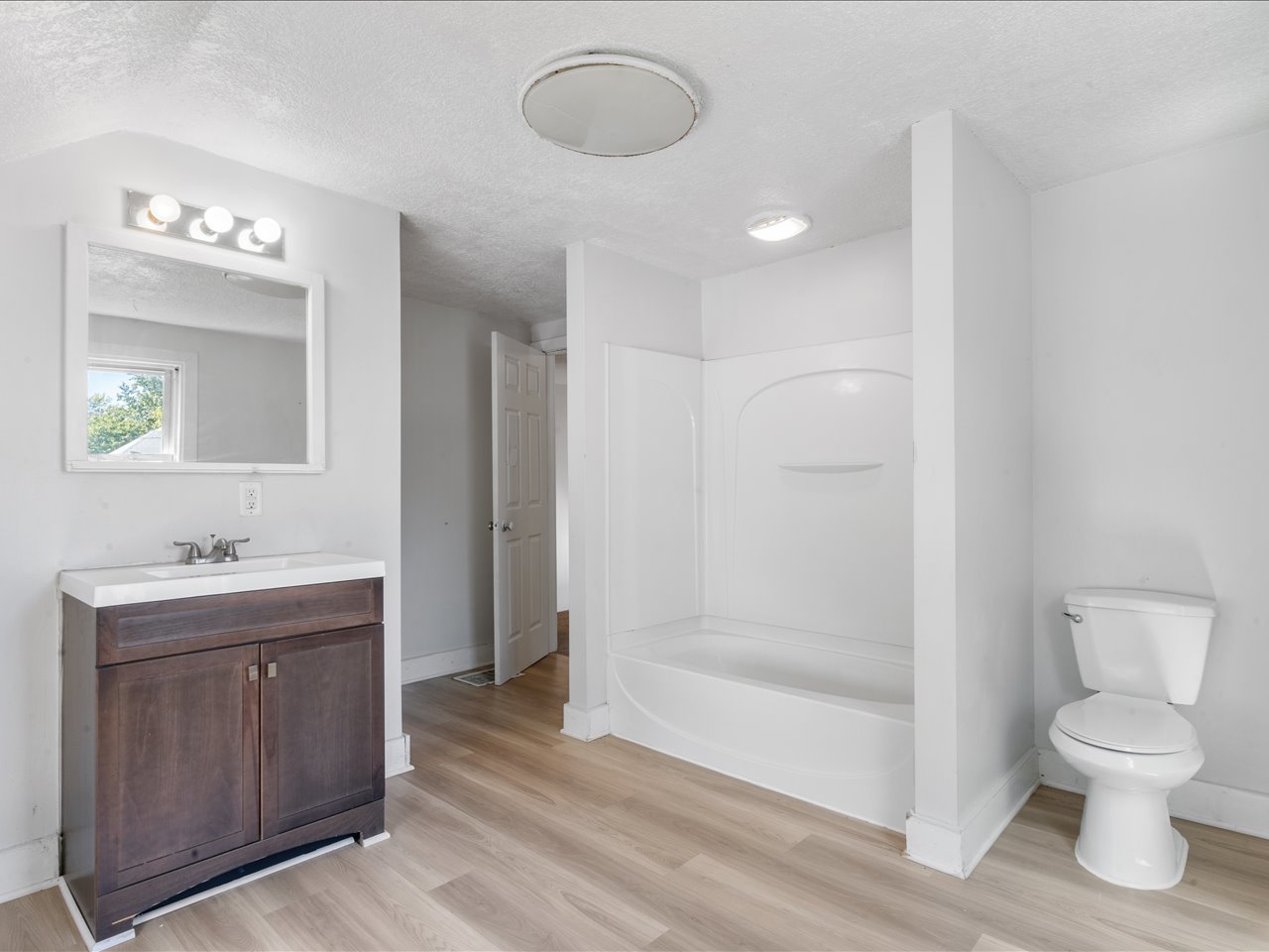 1186 24th Street Moline, IL 61265 - Photo 24 of 27 a bathroom with a toilet a sink and mirror