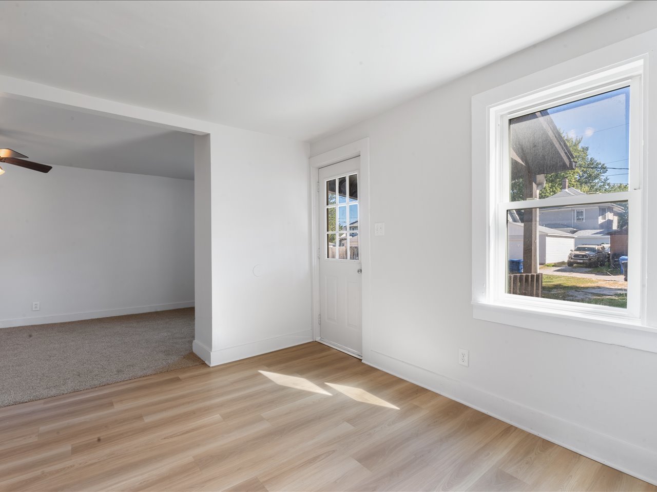 1186 24th Street Moline, IL 61265 - Photo 8 of 27 a view of an empty room with wooden floor and a window