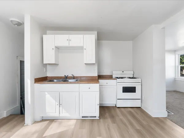 a kitchen with a sink stove and cabinets