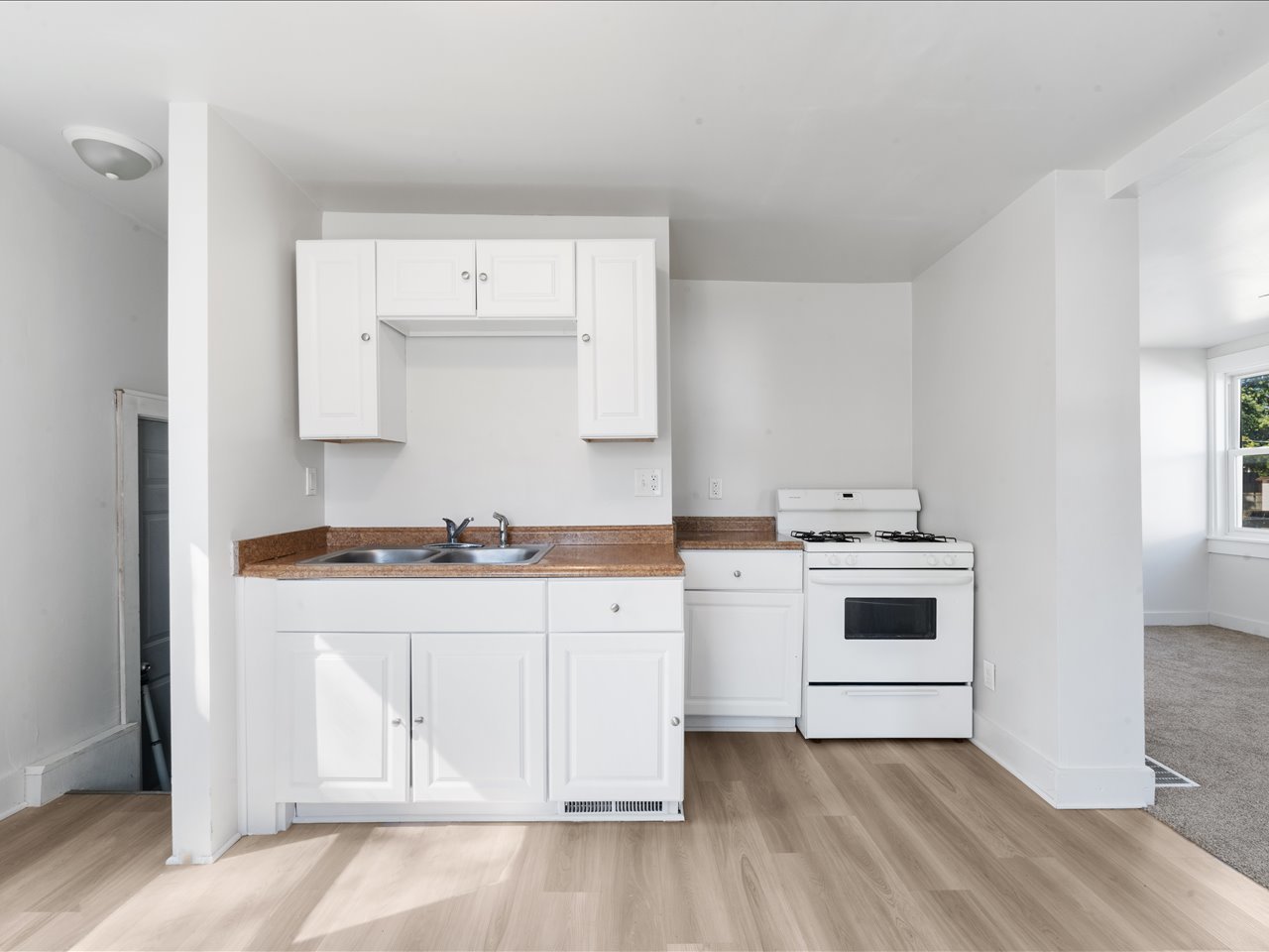 1186 24th Street Moline, IL 61265 - Photo 9 of 27 a kitchen with a sink stove and cabinets