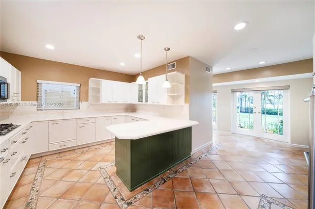 a kitchen with stainless steel appliances granite countertop a sink and a stove