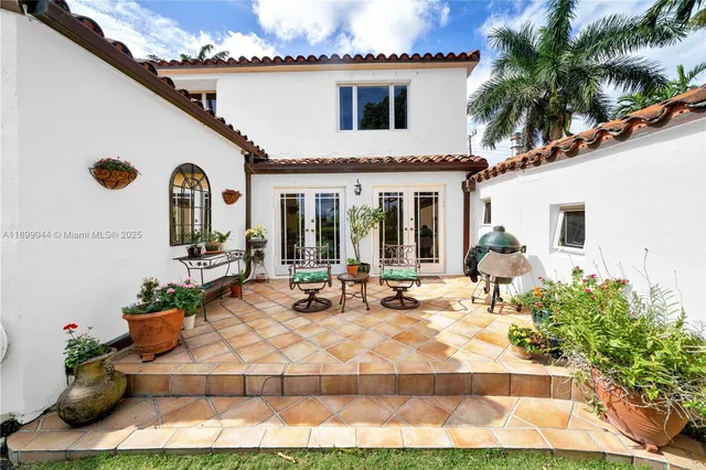 a view of a house with backyard outdoor seating area and furniture