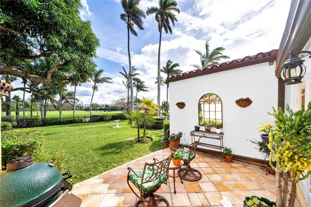 a view of a backyard with sitting area furniture and garden
