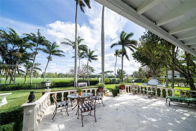 a view of a chair and tables in the patio
