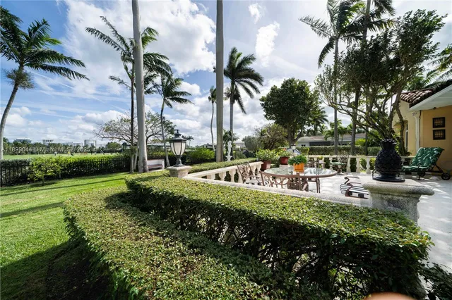 a view of a garden with lawn chairs and a fire pit