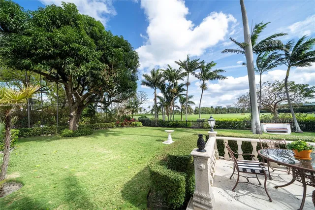 a view of a lake with a garden and swimming pool
