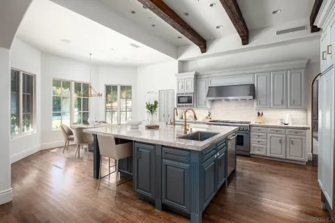 a kitchen with stainless steel appliances granite countertop a lot of counter space and wooden floors
