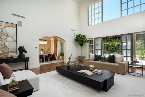 a living room with fireplace furniture and a large window