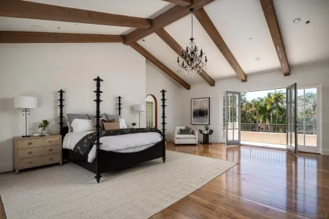 a spacious bedroom with furniture and a fireplace
